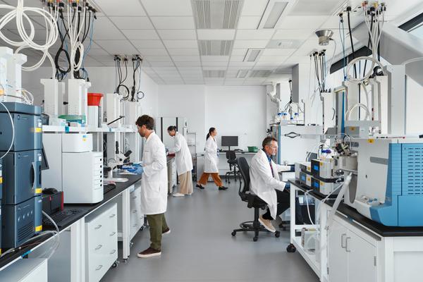 A group of researchers using advanced technology in a lab to develop innovative treatments