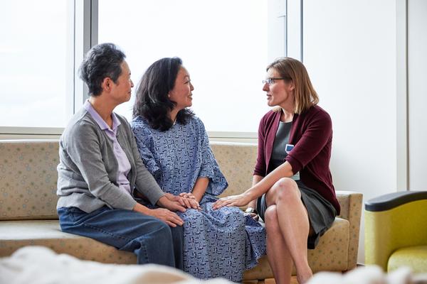 A couple sitting and speaking with a healthcare provider